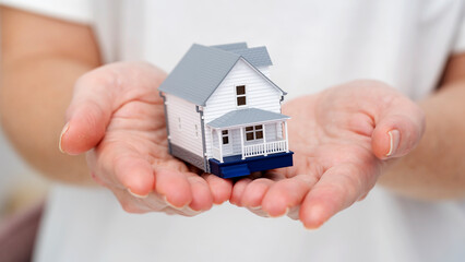the model of the house in the hands of a realtor