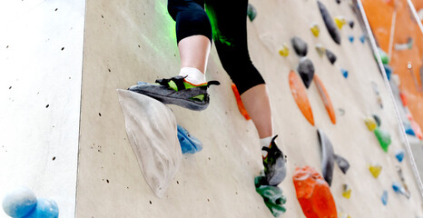 a girl or a guy on a climbing wall