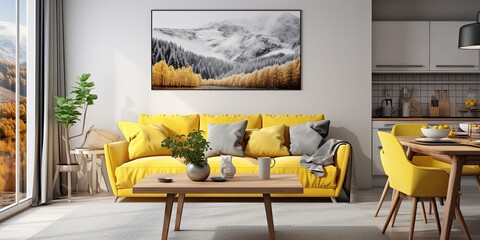 Real photo of a poster above a grey sofa with yellow cushions in an open space interior with dining table chairs.