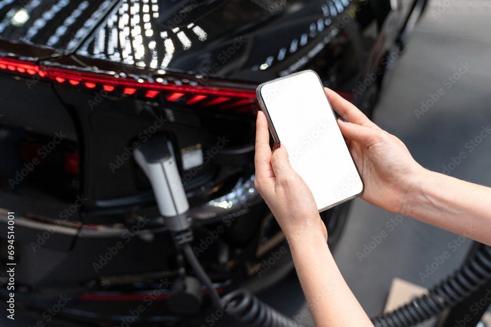Poster hands with smartphone and charging plug on a background of electric car . white screen, you can add 