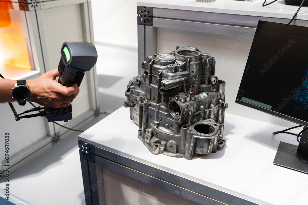 Poster engineer scans the detail with 3d scanner for reverse engineering..