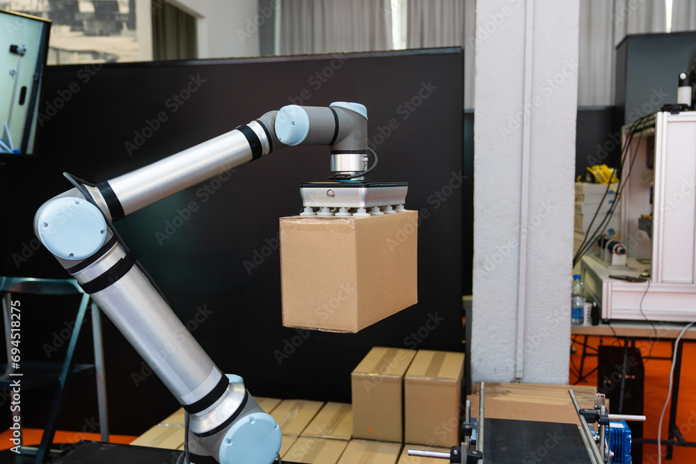 Poster robot arm moves box in an automatic warehouse