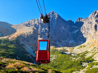 TATRANSKA LOMNICA, SLOVAKIA  October 18, 2023: red cable car goes to the Lomnicky Stit, High Tatra,...