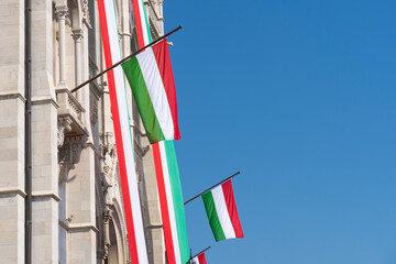 The balcony of the neo-Gothic building of the Hungarian legislature, the Parliament, is decorated with flags in Hungarian national colors on a national holiday