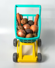 Natural vegetables from the hypermarket in a baby grocery cart