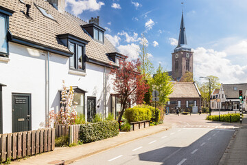 Village Abcoude with the 15th-century Protestant village church in Gothic style in the background. - obrazy, fototapety, plakaty