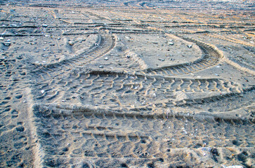 Car tire track. Tire tracks on sandy ground.