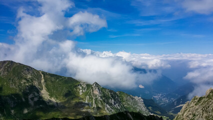 Fototapeta premium Scenic mtb trail along ancient pathway from the Alps to the sea, through the Italian regions of Piemonte and Liguria, and France. Looking at endless mountain ranges and lush green pastures and hills.