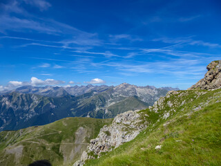 Scenic mtb trail along ancient pathway from the Alps to the sea, through the Italian regions of Piemonte and Liguria, and France. Looking at endless mountain ranges and lush green pastures and hills.