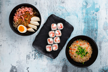 Rice with chicken, dashi broth and sushi maki rolls with shrimp.