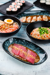 Tuna fillet with yuzu sauce and lemongrass, rice with chicken, dashi broth, sushi maki rolls with shrimp and calamari.