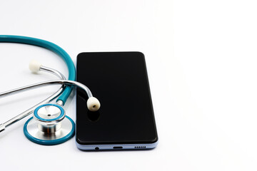 A stethoscope next to a mobile phone