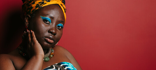 Close-up of gorgeous plus size African woman with beautiful make-up wearing traditional attire 