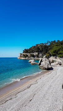Scenic view of beautiful sand beach along the coastline of the golf of Trieste in Friuli-Venezia Giulia, Italy, Europe. Blue sky in tranquil atmosphere at Adriatic Mediterranean sea in summer