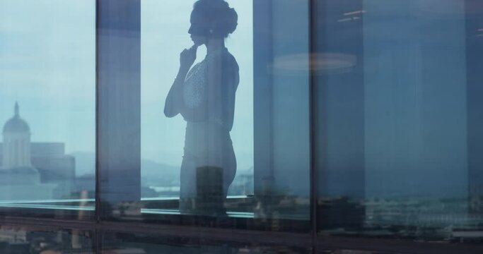 Business, woman and window with thinking of idea, strategy or planning for proposal or corporate decision. Professional, employee and reflection at workplace or office with thoughtful for analysis