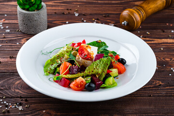 Fresh salad of fresh cucumber, tomato, sweet pepper, lettuce, feta cheese, olives, beets and Dijon mustard.