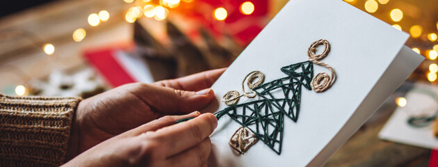 Craft handmade Christmas card with cute new year tree embroidering with wool thread. Made from...