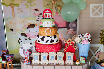 a farm birthday decoration with sweets and farm trinkets
