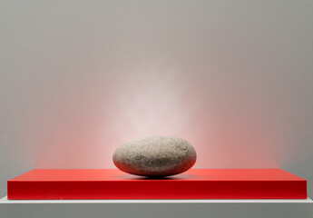 red and white podium with stones for product presentation