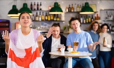Group of fans of England team are upset by oss of their favorite team and express negative emotions in a beer bar - obrazy, fototapety, plakaty