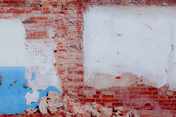 Old grungy red brick wall. Free space for an inscription. Can be used as a background or poster. Fragment of a wall with bumps and peeling paint.