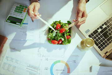 business owner woman in green office eating salad
