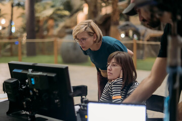 Director at work on the set. The director works with a group or with a playback while filming a...