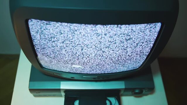 Top view old TV and video recorder,VCS cassette being inserted into the player