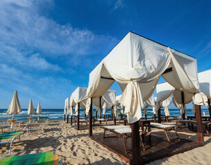 Luxury beach tents canopies on morning paradise white sandy beach Maldives of Salento (Pescoluse,...