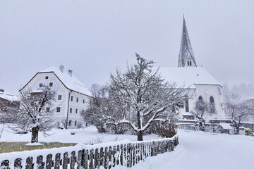View of snow-covered Bramberg, with the village church in Salzburger Land, Austria,