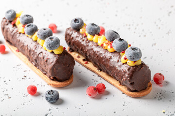 Tasty chocolate bar with sour cream and berries.