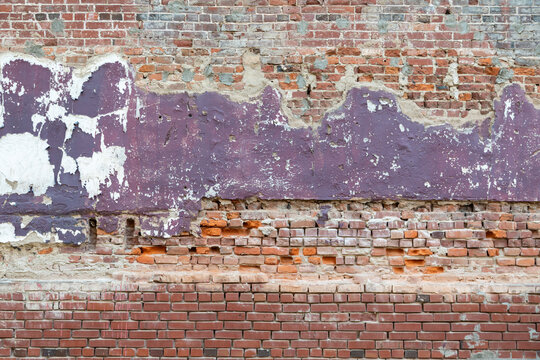 Purple Peeling Paint and Plaster on an Old Red Brick Wall, Memphis Tennessee