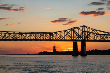 Silhouette of John R Junkin Drive Bridge Over the Mississippi River at Dusk, With Orange Sky,...