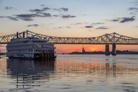 A Paddle Wheeler Cruise Ship at Sunset in Front of the John R Junkin Drive Bridge over the Mississippi River in Natchez, Mississippi 