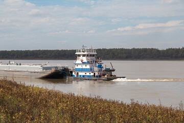 Tow Boat Pushing Barges Down River on the Mississippi River Near St. Francisville, Louisiana