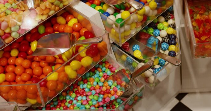 The video displays an assortment of various chewing gums and lollipops being sold in bulk.
