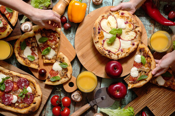 Pizza with sausage, mushrooms and apples with fresh vegetables and greens
