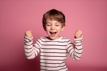 A young boy Celebrating a special occasion birthday, with joy and happiness in a studio setting with colorama backdrop