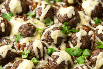 French onion beef meatballs in iron cast pan.
