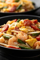 Char kway teow with rice noodles, prawn, sausages, egg and vegetables