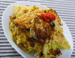 Close up of vegetarian dish of leaves of cabbage in batter on a plate