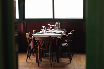 Luxurious Restaurant Table with shiny cutlery. Opulent Setting for Fine Dining Experience. High end restaurant. Romantic dinner in sunset light. Sunlight table. Wine glass.