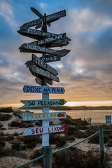 Handmade wooden direction signs of several beaches and respect for the environment at sunset, Milfontes PORTUGAL - obrazy, fototapety, plakaty