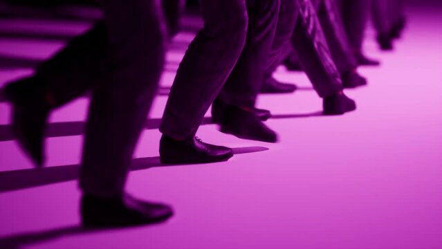 3d render animation through a long lens of dancing male legs. They copy the movement and there is a short delay between them. They are wearing a suit and a purple background