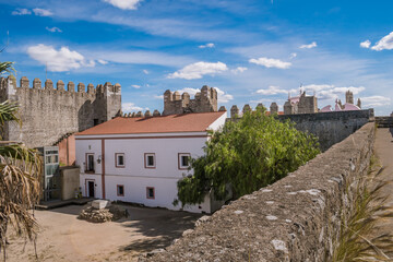 Ramparts in perspective with herbs and several towers and view to the forecourt of Serpa castle, Alentejo PORTUGAL