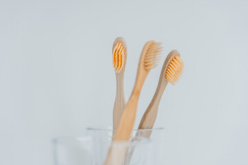  toothbrush.Teeth cleaning.Toothbrush in bathroom. Hand takes a toothbrush from a transparent glass...