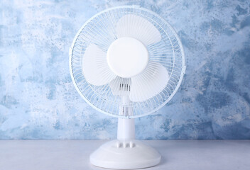 Electric fan on blue grunge background