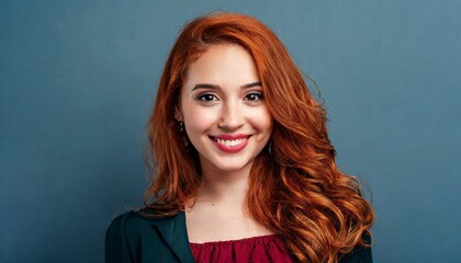Fototapeta premium Portrait of beautiful cheerful redhead girl, blue background
