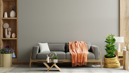 Cozy living room with grey sofa on dark wall and wooden flooring - obrazy, fototapety, plakaty