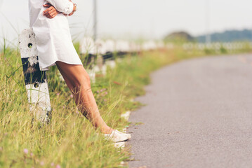 Woman traveller walking on road relaxation. Women wear sneaker shoes walking on summer park. Females standing in green park on forest pathway outdoors. Young traveler relaxing vacation in walk way - obrazy, fototapety, plakaty
